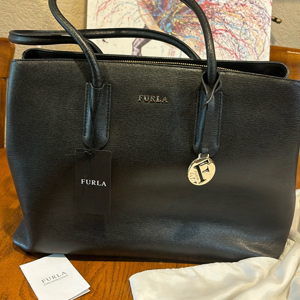 FURLA Satchel black leather 14” L, 10” or 18” with handles H, 5” W.